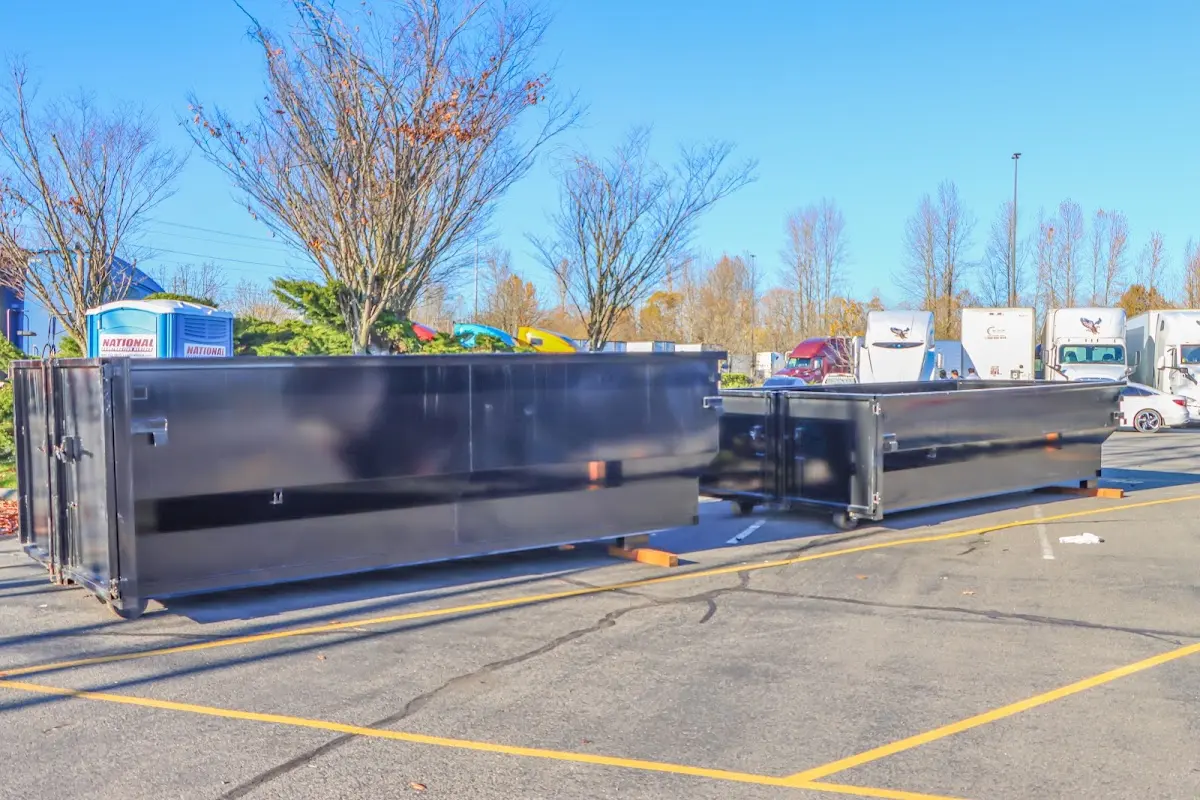 Professional dumpster rental service with roll-off container on residential driveway in Greensburg